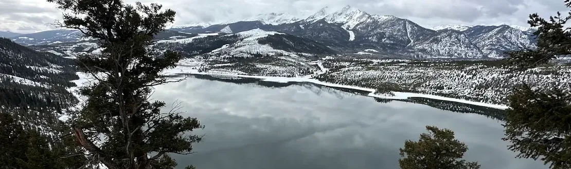 View from the rocks at Sapphire Point over Dillon Reservoir, snow on the surrounding mountains