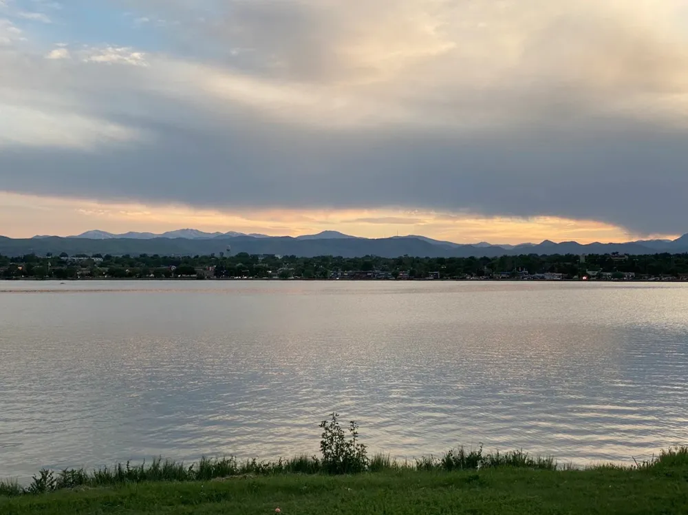 Dusk over Sloan's Lake in Denver, with the Front Range silhouetted across the water